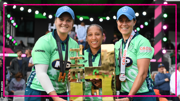 Oval Invincibles players Dane van Niekerk (left), Shabnim Ismail (centre) and Marizanne Kapp (right) hold up the trophy after winning the women's Hundred