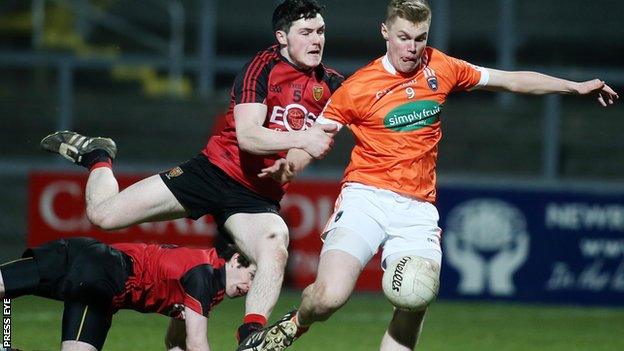 Down defender Jamie Donnan challenges Armagh's Oisin O'Neill in the U21 clash at Pairc Esler