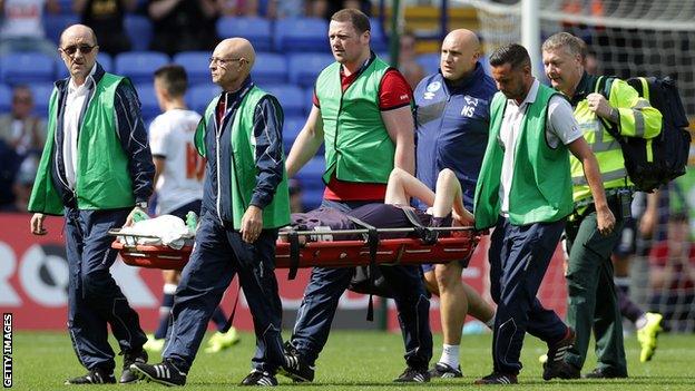 Will Hughes is taken off on a stretcher after being injured during Saturday's draw at Bolton