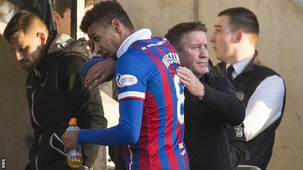 Inverness Caledonian Thistle striker Nathan Austin leaves the field consoled by manager John Robertson