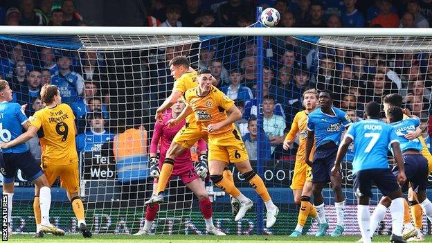 Lloyd Jones scores an own goal against Peterborough