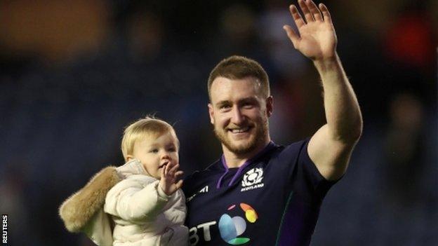 Stuart Hogg celebrates with his daughter after Scotland's win over Fiji