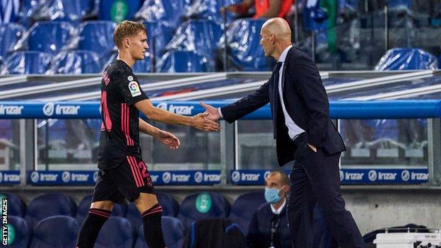 Martin Odegaard shakes hands with Zinedine Zidane