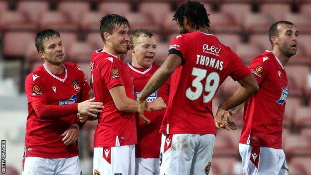 Wrexham players celebrate Luke Young's goal