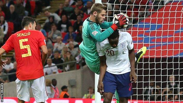 Danny Welbeck and David de Gea challenge for the ball in the incident that led to England's disallowed goal