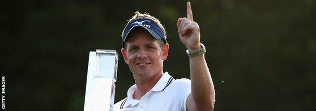 Luke Donald of England holds the trophy following his victory in a playoff on the 18th green, which also secured him the Number one World ranking during the final round of the BMW PGA Championship at the Wentworth Club