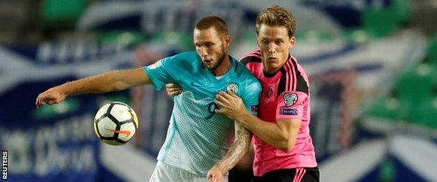 Christophe Berra contest the ball against Slovenia