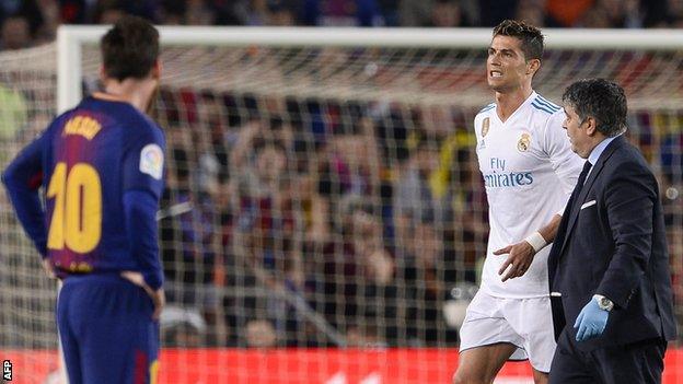 Real Madrid forward Cristiano Ronaldo reacts after suffering an injury against Barcelona