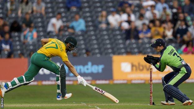 Ireland's Lorcan Tucker tries to run out South Africa's Reeza Hendricks