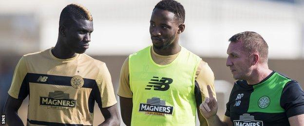 Manager Brendan Rodgers (right) chats to new signing Kouassi Eboue and striker Moussa Dembele