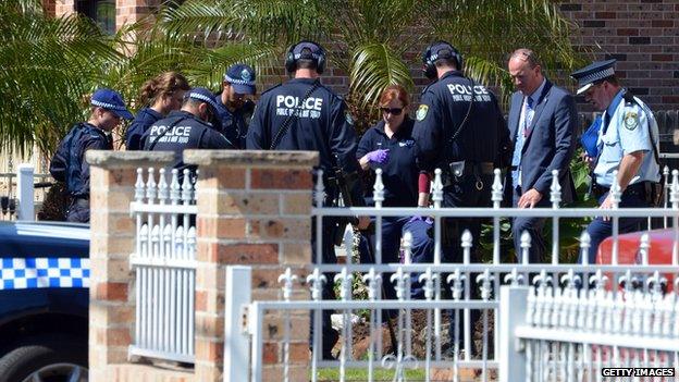 Forensic experts collect evidence from a house in the Guildford area of Sydney on September 18, 2014.