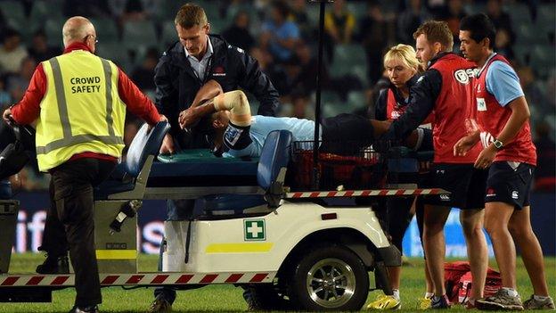 Kurtley Beale is taken off on a stretcher after being injured