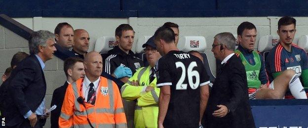 Chelsea manager Jose Mourinho watches on as John Terry leaves the pitch after his red card