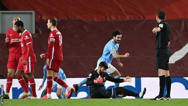 Alisson looks dejected after making an error that led to Ilkay Gundogan putting Manchester City 2-1 up