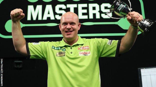 Michael van Gerwen holds the Masters trophy