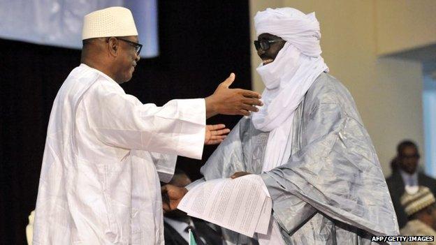 Mali"s President Ibrahim Boubacar Keita (L) embrasses Mahamadou Djery Maiga (R), the vice-president and spokesman of the Transitional Council of the State of Azawad, following the signing of the ammended version of the Algerian Accord on June 20, 2015 in Bamako.