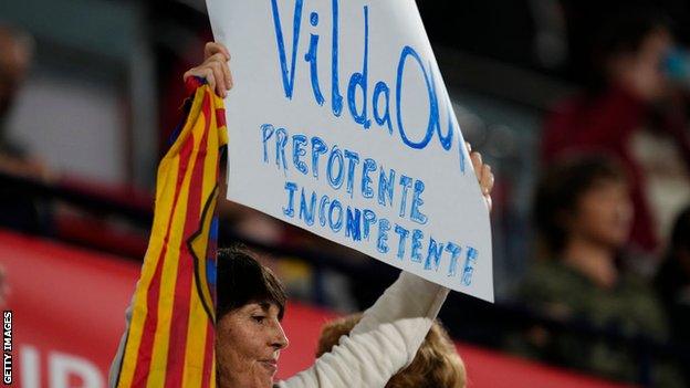 A fan holding a sign saying 'Vilda Out'