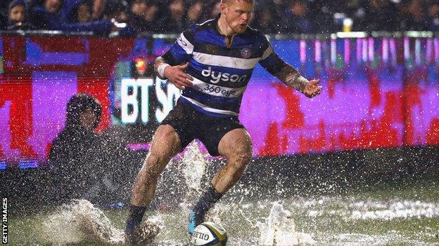 Bath's Tom Homer attempts to gather the ball out of a puddle