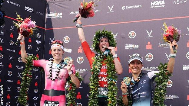 Lucy Charles-Barclay of Great Britain (2nd), Chelsea Sodaro (1st) and Anne Haug of Germany (3rd) celebrate after finishing the Ironman World Championships in Kailua Kona, Hawaii.