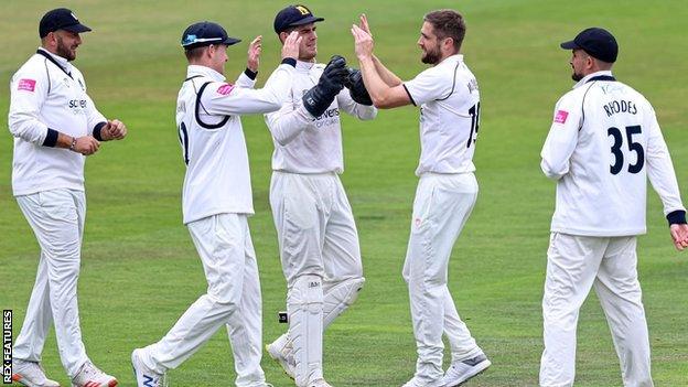 Warwickshire's Chris Woakes celebrates taking the wicket of England team-mate Dawid Malan at Headingley