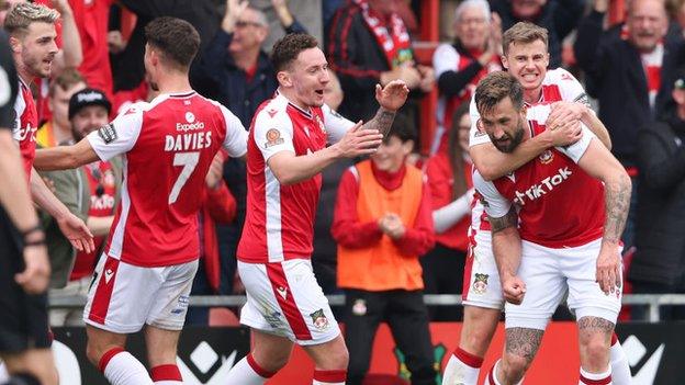 Ollie Palmer celebrates with Wrexham team-mates after scoring the opening goal