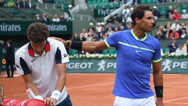 Rafael Nadal consoles fellow Spaniard Pablo Carreno Busta