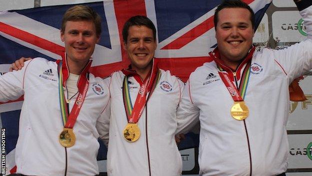 Tim Kneale (centre) celebrates winning the double trap team world title with Matt Coward-Holley and Matt French