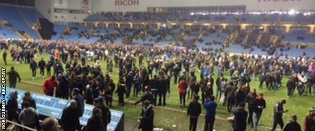 Coventry City fans take to the pitch after their EFL Trophy semi-final win over Wycombe Wanderers