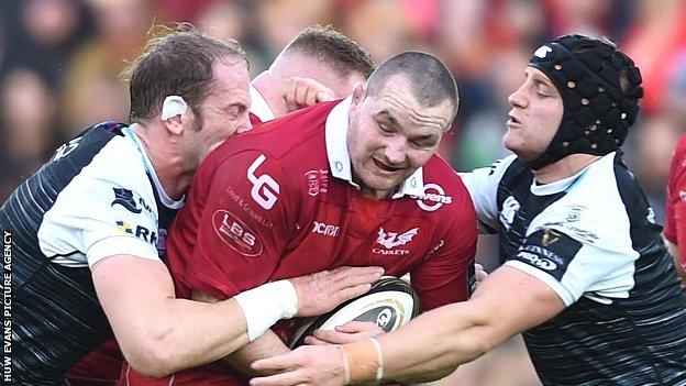 Scarlets hooker Ken Owens is tackled by Ospreys skipper Alun Wyn Jones