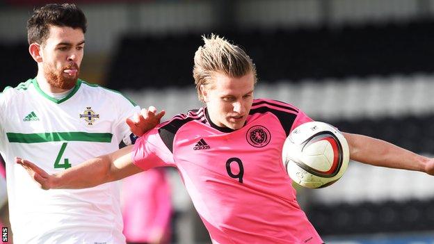 Liam Donnelly takes on Jason Cummings during a Northern Ireland v Scotland under-21 international