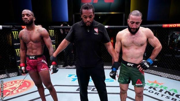 Leon Edwards, the referee and Belal Muhammad as the fight is declared a no contest