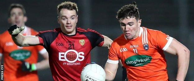 Armagh's Conor White attempts to burst away from Down's Brendan McArdle