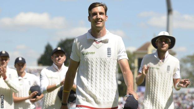 Steven Finn leads England off after their win