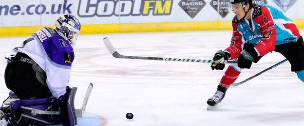 Braehead netminder Gary Russell wins this race for the puck with Belfast's Michael Forney