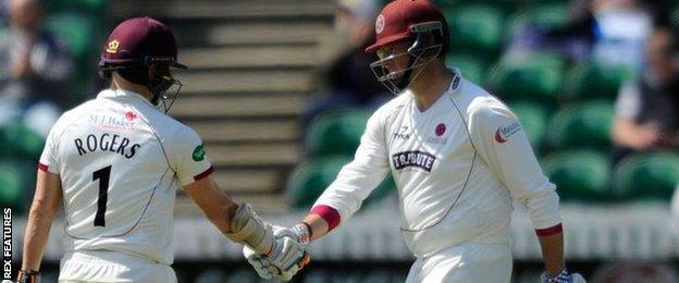 Marcus Trescothick celebrates his half century against Yorkshire at Taunton with Somerset captain Chris Rogers