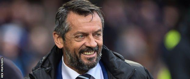 Phil Brown smiles on the sidelines