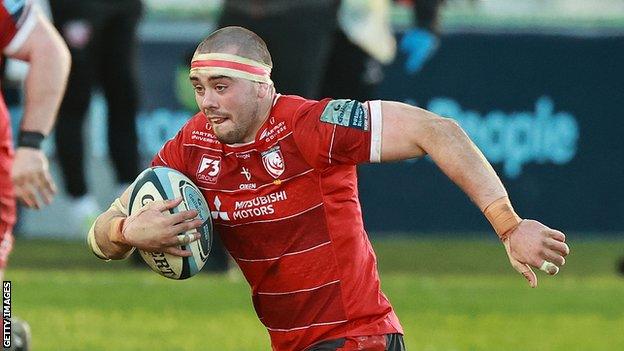 Lewis Ludlow runs with the ball while playing for Gloucester