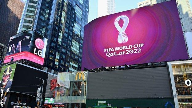 The official 2022 FIFA World Cup Qatar logo flashes on an electronic billboard at Times Square