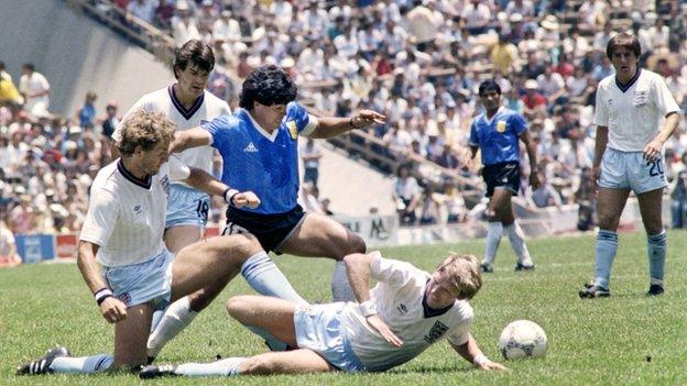 Argentinian's Diego Maradona (C) dribbles past three English defenders