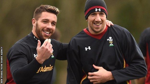 Rhys Webb (l) drapes his arm over Justin Tipuric as the pair share a joke during a Wales training session