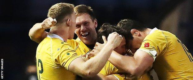 Reece Hodge, Nick Phipps and Tom Robertson celebrate after Australia's win over Scotland earlier this month