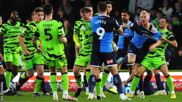 A scuffle breaks out after Wycombe's Josh Scowen is fouled by Regan Hendry of Forest Green Rovers