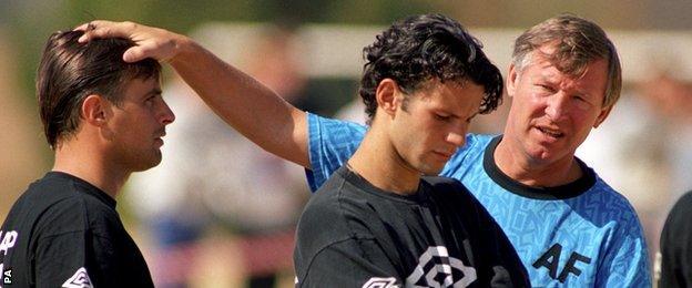 Ryan Giggs looks unhappy as Sir Alex Ferguson puts a hand on Clayton Blackmore's head in South Africa in 1993