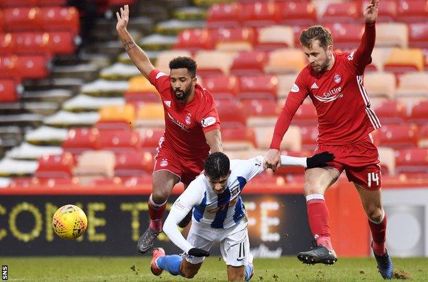 Kilmarnock winger Jordan Jones brought down by Aberdeen's Shay Logan and Kari Arnason