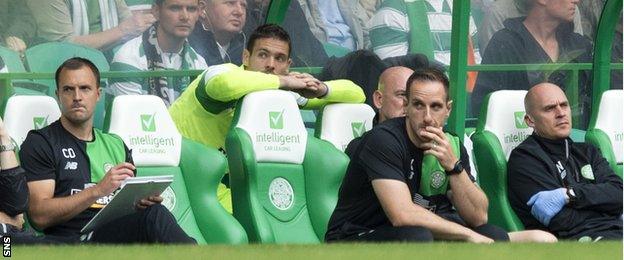 Craig Gordon watches Celtic's game against Aberdeen from the bench