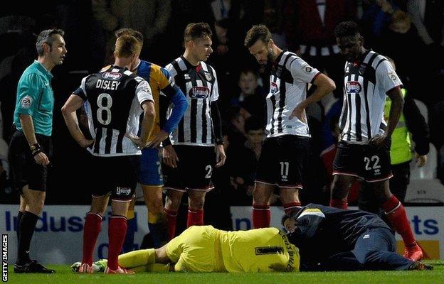 Shrews goalkeeper Jayson Leutwiler was stretchered off after a collision with Andy Monkhouse