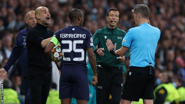 Man City boss Pep Guardiola with referee Daniele Orsato