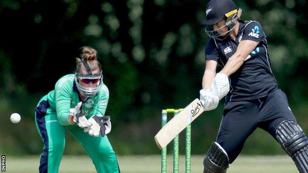 Ireland wicketkeeper Mary Waldron can only look on as New Zealand opener Sophie Devine plays a shot