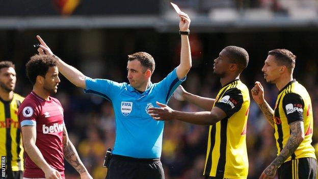 Referee Chris Kavanagh (centre) shows a red card to Watford defender Jose Holebas (far right) against West Ham