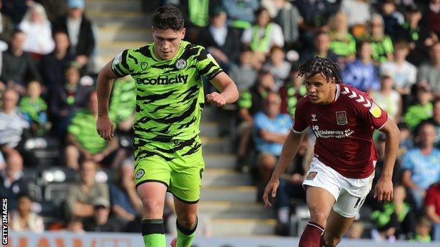 Matty Stevens runs away from Northampton's Shaun McWilliams with the ball